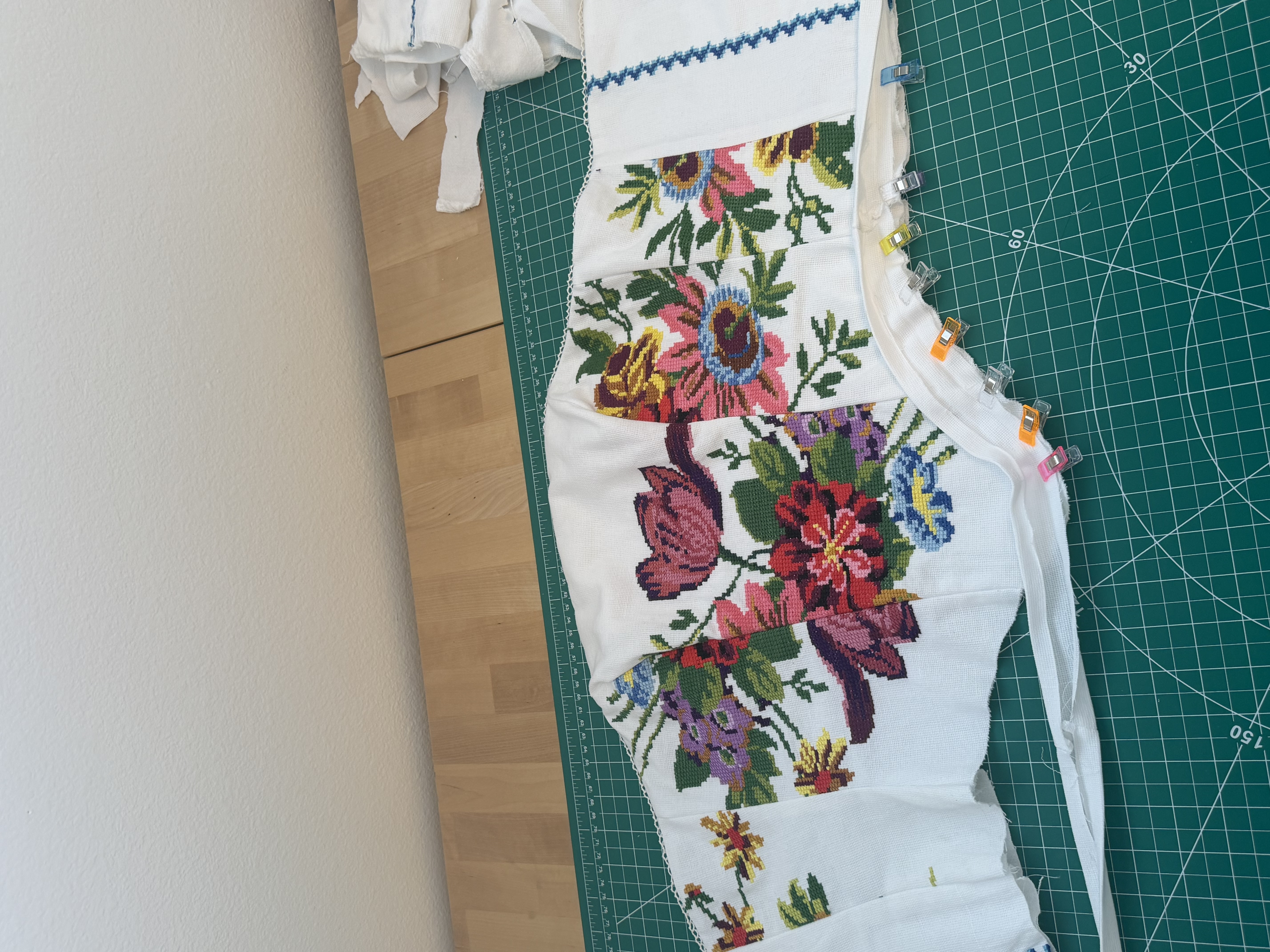 The plain white pillowcase fabric used as bias tape along the bottom edge, next to the blue zigzag trim